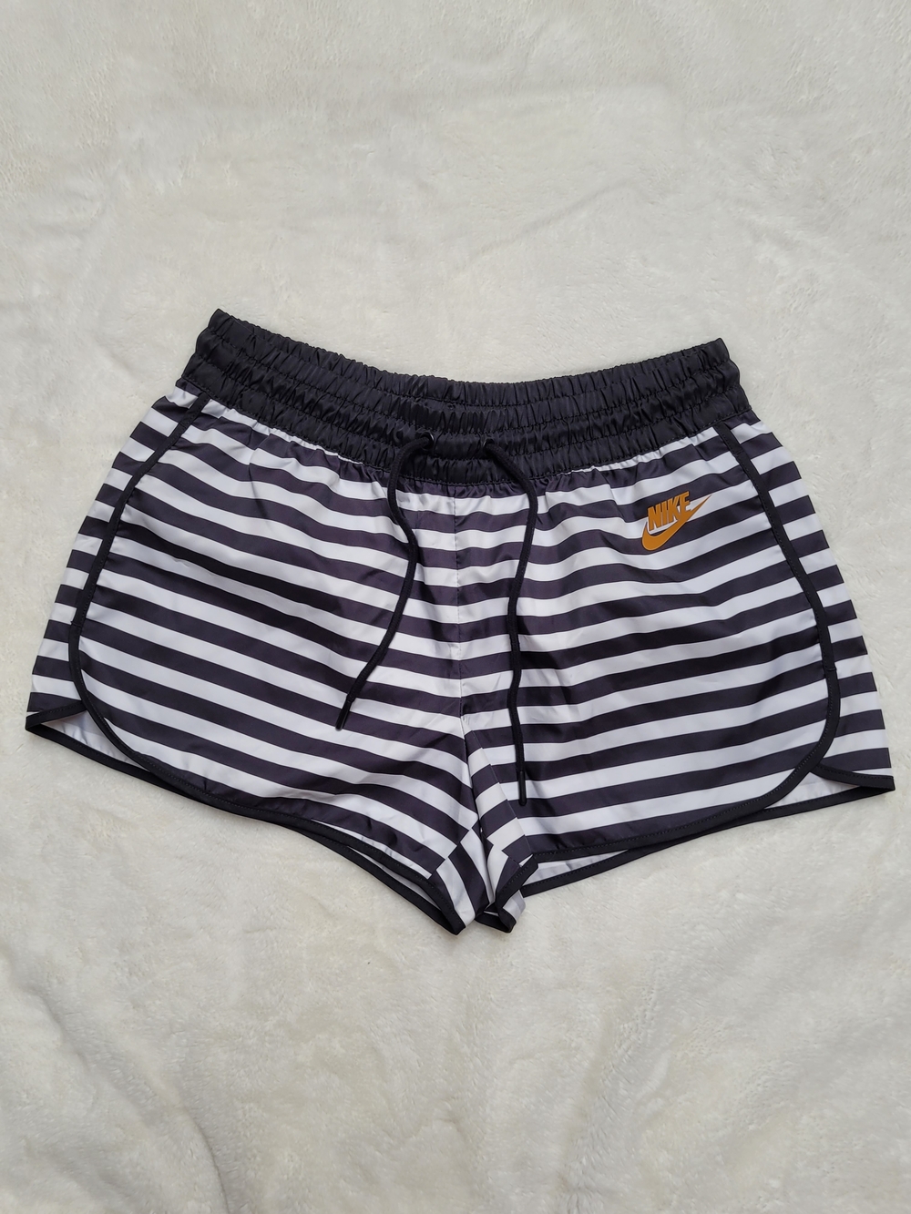 Nike Women's Black & White Striped Athletic Shorts with Gold Logo